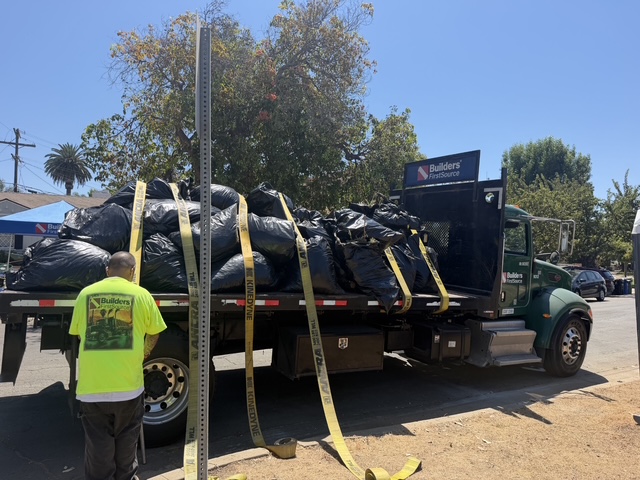 Builders FirstSource truck loaded with cleanup materials during Community Clean Up Day